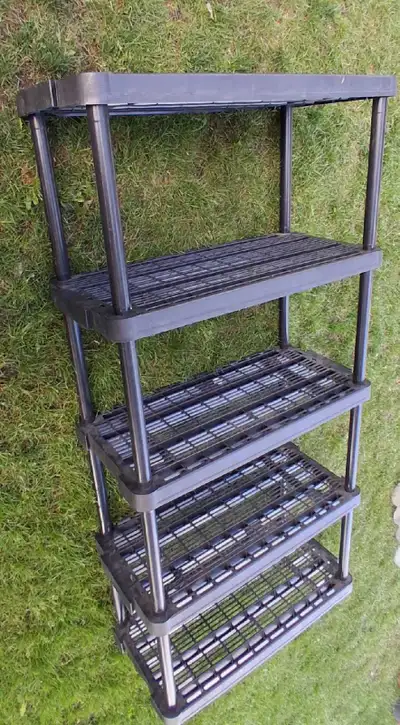 Durable black plastic shelving unit has five ventilated tiers. This storage rack is constructed from...