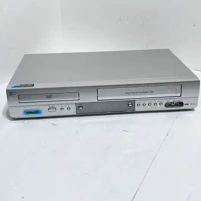 Experience nostalgic entertainment with this used Zenith ZDV-712 DVD/VCR Combo Player, a versatile d...
