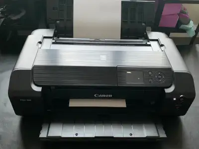 Professional grade Canon printer. Works perfectly, only 568 pages printed total. Some of the ink is...