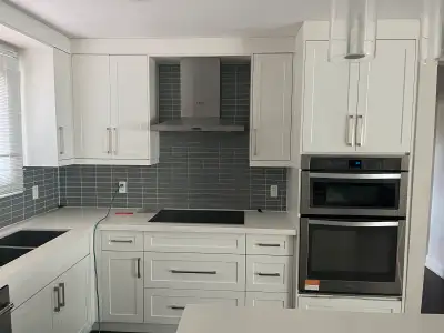kitchen Cabinets, Island and electric cooktop with hood., View more