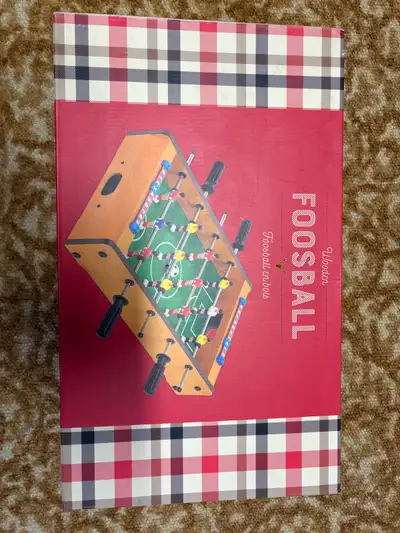 Spruce up your game room with this wooden foosball table! It's in good condition, offering hours of...
