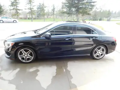 2 liter engine, AMG styling, night black exterior with brown/black interior, panoramic sunroof, and...