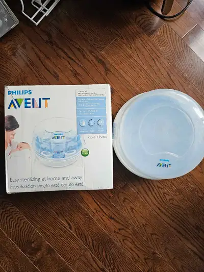 Offering a baby bottle sterilizer, complete with its original packaging. The item consists of a roun...