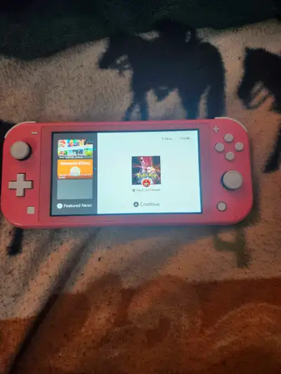 Dive into fun with this coral Nintendo Switch Lite! While it's been on a few adventures, it's still...