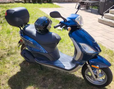 Selling mint condition almost new piaggio fly 150CC, comes with new helmet and top box. If the ad is...