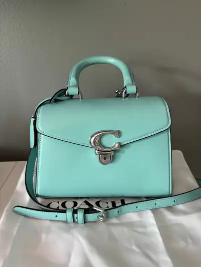 Used once, comes with strap and hang tag.