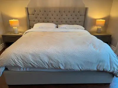 King size upholstered bed frame with studded head board. Like new and in very good condition. Just m...