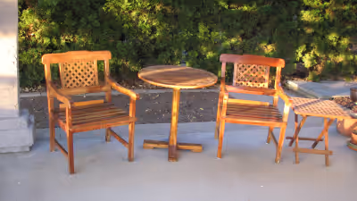 Teak patio furniture Includes dining table, side table, two armchairs, chair cushions. Solid teak, v...