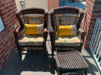 Two rattan-style patio chairs