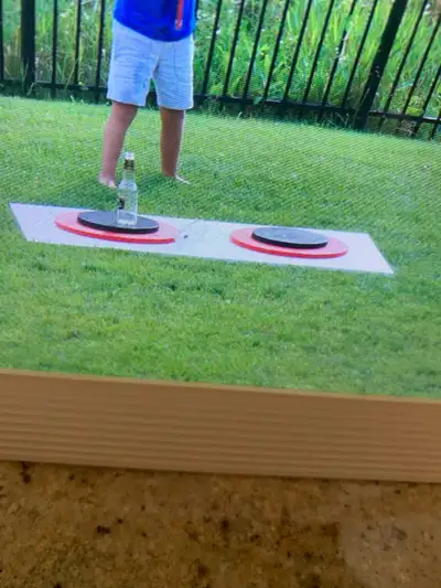 Large homemade game. Use pole with rings to try and stand up the bottle. Two people can go against e...