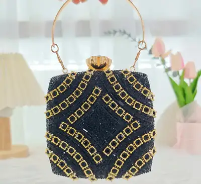 This is a used, black beaded and gold tone clutch with a top handle and detachable chain strap, perf...