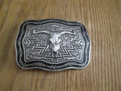 Cow skull belt buckle by Crumrine. In as new condition. Buckle measures 3 1/4 inches by 4 3/4 inches...