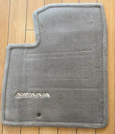 I am selling a set of used carpet floor mats for a Toyota Sienna minivan. These mats are designed to...
