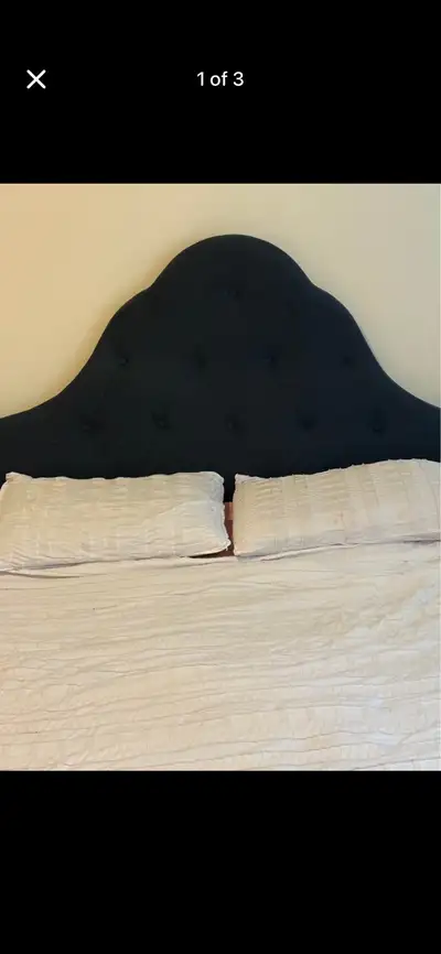 Navy blue upholstered bed frame has a velvet-like fabric material. The headboard features a curved,...