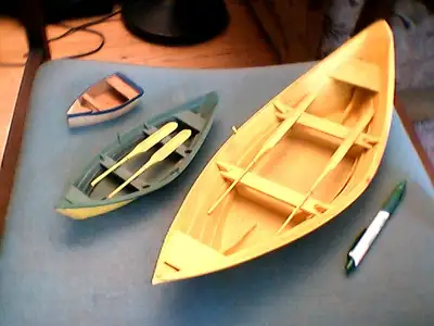 These appear to be handcrafted pieces. There is an identical stamp on the base of the 2 larger boats...