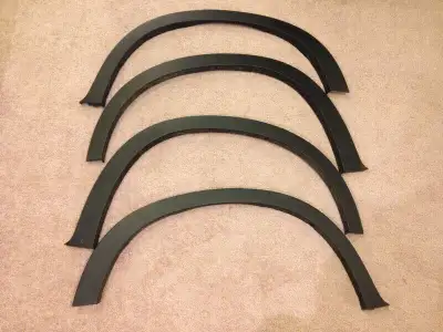 4 original fender flairs to fit all season original factory tires. NEW. All 4 $300 or $100 each.