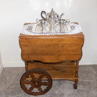 Mahogany tea wagon complete with tea service. Tea wagon made by a furniture co. in Elora, a small to...