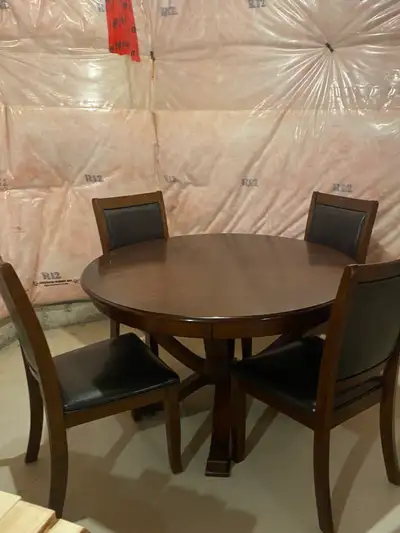 A warm and sturdy wooden dining table-comfortably seating four people. Perfect for family meals and...