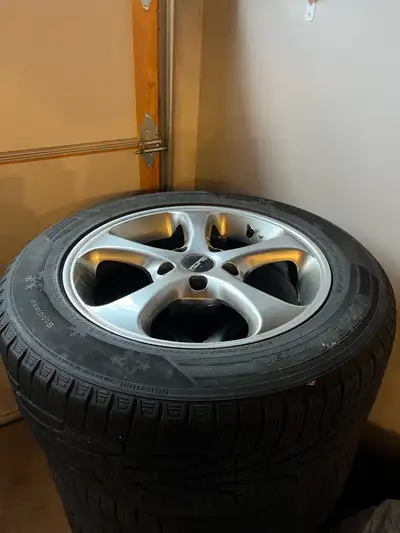 These are used winter tires on rims, perfect for getting through the snowy months with confidence. T...