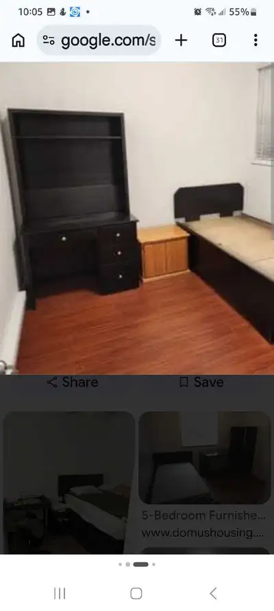 This furnished room offers a comfortable and organized living space featuring a bed frame, desk, and...