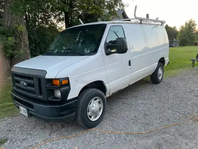Ford e 250 4.6L v8 200k runs ac works needs some tlc but has ladder rack devider & shelving. Located...