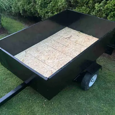 3.5ft wide x 5ft long trailer with a fold down rear gate and trailer also tilts. Fresh paint and flo...