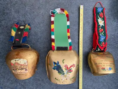 This set of 3 vintage Swiss cow bells features a charming collection of authentic, pre-owned decorat...