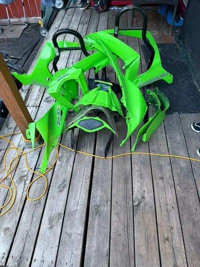 I have Kawasaki fairing parts and front and back racing stands. $200 for everything.