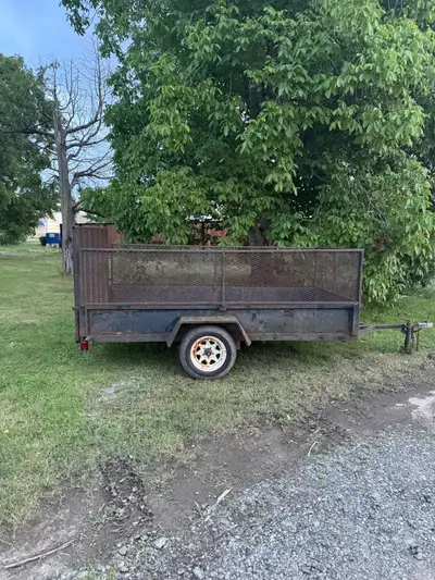 This is a used trailer that is ready to haul! This trailer has a mesh cage surrounding the parameter...