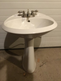 Bathroom pedestal sink, taps and matching light fixture.
