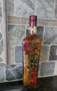 Decorative bottle filled with peppers and rosemary, 