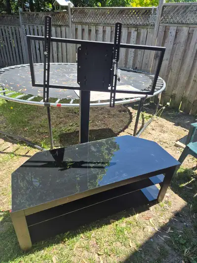 This used TV stand features a sleek, tempered black glass top and an integrated mounting bracket, ma...
