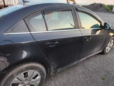 Black Chevy Cruze for sale As Is. Needs Rocker Panels and little to safety. Has set of Winter tires...