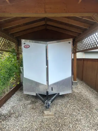 This 2023 Action enclosed trailer features a 6x12 ft cargo area with a V-nose design, perfectly suit...