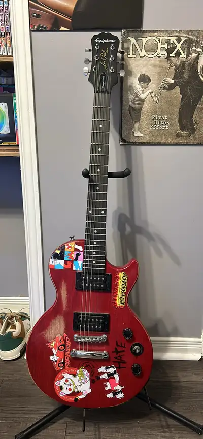 Epi les paul vintage series. Guitar looks worse than it is, ive taken good care of it over the years...