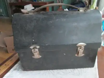 black outer and a cream inside, good for work, travel, camping, and other things, made of metal with...