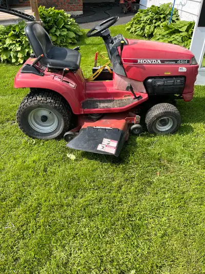 Honda riding lawnmower, hydrostatic needs deck belt, battery, and One front tire leaks, and has an o...