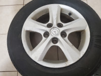 Two Mazda alloy rims with one new 195/65/15 summer tire