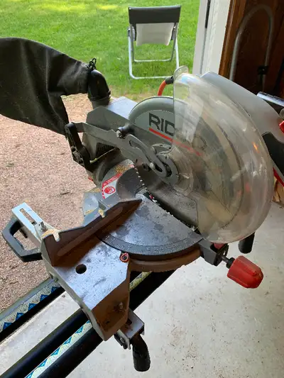 Price drop, Rigid Brand 10 inch compound mitre saw with sturdy collapsible stand for sale. Comes wit...