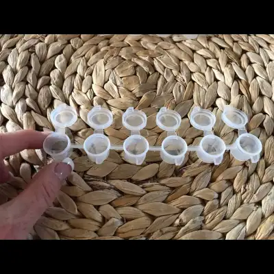 These are tiny plastic containers normally used to store paint when drawing dot mandalas or other po...