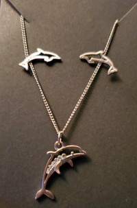 Silver Dolphins earrings and necklace set with crystals.