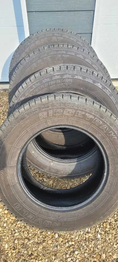 Rovelo Ridgetrak AT 265 75 R18. Very good condition, just measured at the dealership at 14/32. Plent...