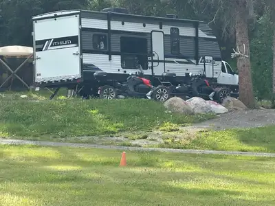This toy hauler is versatile. It has king size bed in the slide out, a drop down queen convertible d...