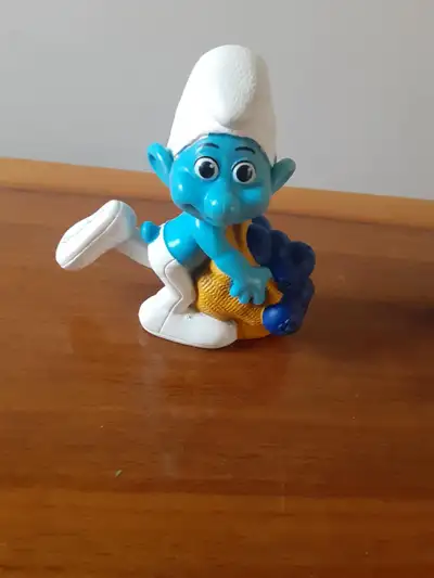 Greedy Smurf toy from the 2011 McDonald's Happy Meal collection. This toy is a collectible item for...