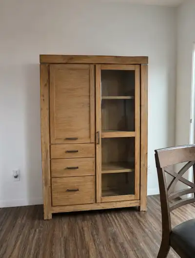 Beautiful rustic-style wooden storage cabinet with shelves, drawers, and a glass door section. Great...