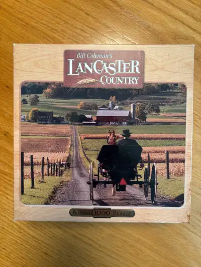 This is a used Bill Coleman's Lancaster Country premium 1000-piece puzzle that offers a scenic view...
