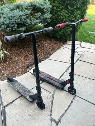 2 MADD GEAR scooters. Red one is a carve elite. Grey one is a MGP kick pro. Everything works like ne...