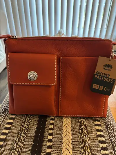 I have a Roots villager bag. Brand new, never used. Tags attached. On my other listing I have a matc...