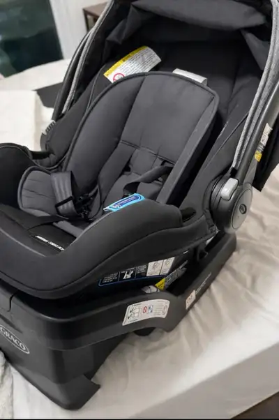 This is a Graco SnugRide SnugLock 35 infant car seat. It's black and grey with a padded interior. Th...