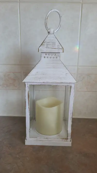 White, brushed white metal with battery operated candle, 9 1/2" high, 4" square, asking $15.00. (2)...